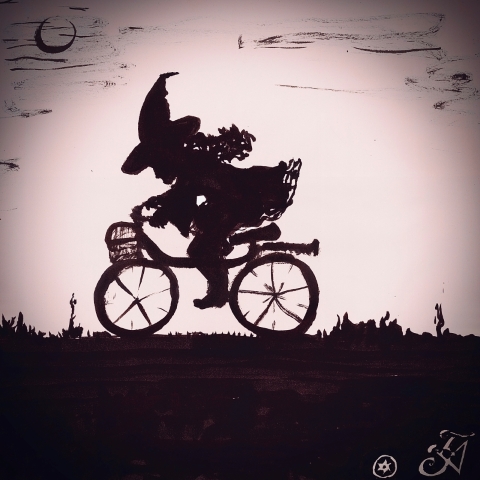 A witch riding a bike in the middle of the night